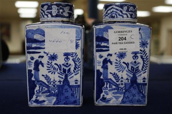 A pair of Dutch delft blue and white lidded tea caddies